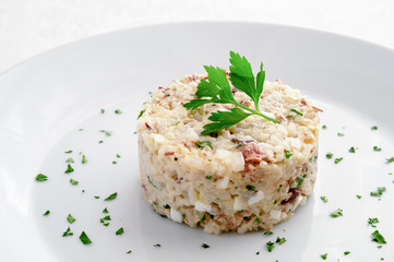 mackerel salad with egg, onion and rice dressed with mayo sauce and  decorated with parsley
