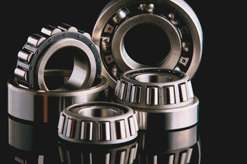 Close-up of a set of ball and roller bearings on a dark background