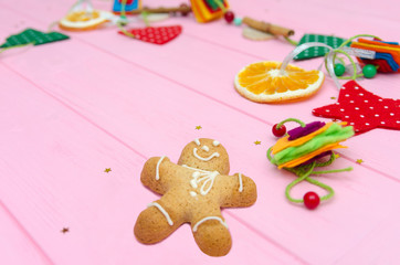 Christmas decoration on pink wood board. Christmas garland background.