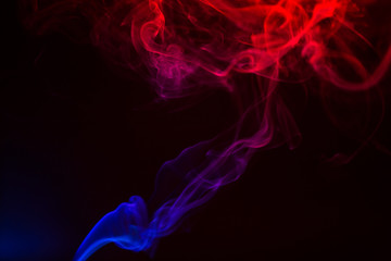 Obraz premium Colorful smoke close-up on a black background