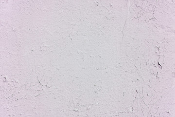 Natural background. Wall with a shabby and peeling paint, crack and plaster.  pink and white
