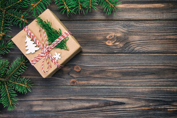 Christmas Background Christmas gift with fir branches on wooden black vintage, toned background with copy space Flat lay, top view