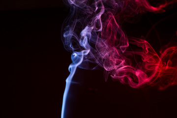 Obraz premium Colorful smoke close-up on a black background