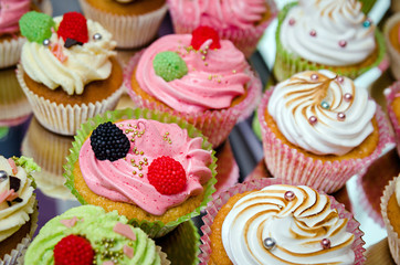 group of tasty cupcakes on a white wooden table
