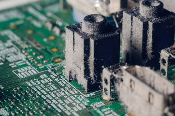 A thick layer of dust covers the internal electronic components of the computer