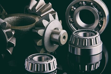 Gears, bearings and differential stars lie on the table close-up