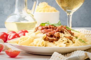 Italian pasta bolognese from pasta penne rigatone minced meat in tomato sauce and parmesan cheese