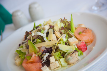 fresh salad with cheese,  seafood and avocado