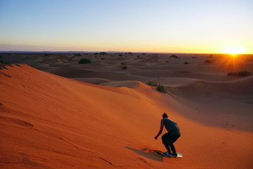 Fototapeta na wymiar Sahara desert, sandboarding, sandboard, Morocco, Africa, desert tour