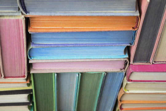 Many old books stacked in texture