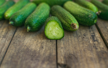 Fresh cucumbers on old wooden table