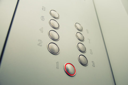 Close-up of blind person finger reading braille on elevator lift panel