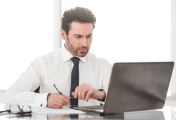 close up. serious businessman checking financial report