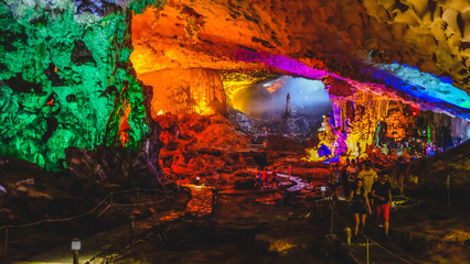 A colourful lit up cave in Ha Long Bay, Vietnam