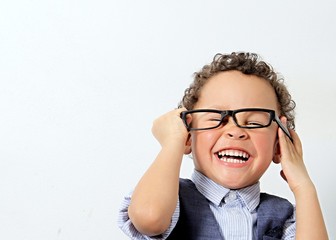 little boy trying a pair of glasses on stock photo 