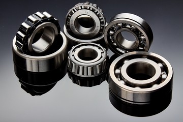 Close-up of a set of ball and roller bearings on a dark background