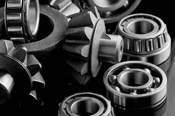 Gears, bearings and differential stars lie on the table close-up