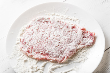 Pork chop lies in flour