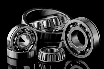 Close-up of a set of ball and roller bearings on a dark background