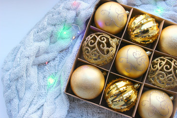 Christmas card is Golden.Christmas decorations on light background. Gold balls on the Christmas tree. Christmas toys in the box. Christmas decorations in gold color, the concept of Christmas, New year
