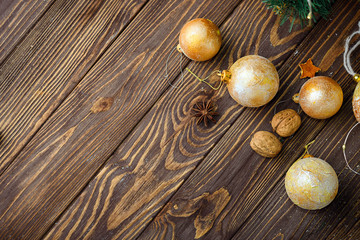 Christmas balls decor and nuts on old wood background with empty place for text