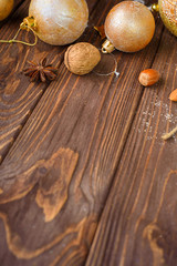 Christmas balls decor and nuts on old wood background with empty place for text