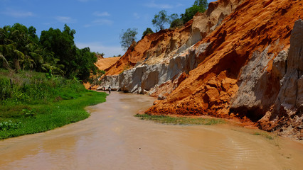 People walk down the colourful Fairy Stream in Mue Ne, Vietnam