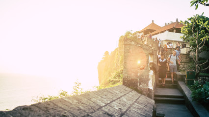 Sun setting over temple in Uluwatu, Bali on the cliff