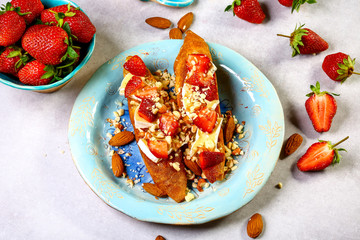 Italian bruschetta with strawberry, nuts and cheese camembert Food homemade recipe concept. Flat lay, close up