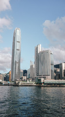 Obraz premium The Hong Kong skyline full of skyscrapers seen from the bay on a boat