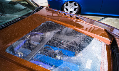 car hood with rain drops