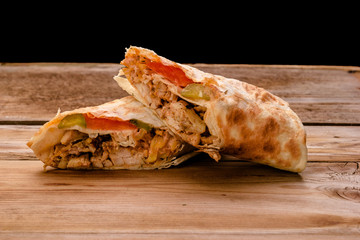Doner Kebab Gyros Shawarma beef roll in pitta bread Wrap sandwich on wooden background