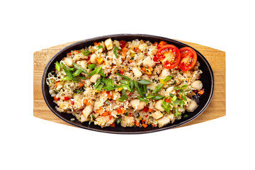 Top view pan of traditional Japanese rice with vegetables and chicken at wooden board isolated at white background.