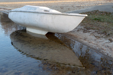 An old boat hull on the edge of the lake. A place of summer recreation after the tourist season.