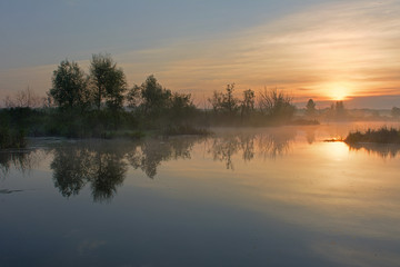 Misty morning over the lake in the summer