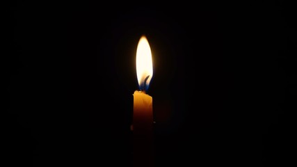 A candle burns in the dark, to light a candle, extinguish the candle.