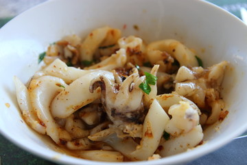 plate of cuttlefish and sunglasses on the table of a french restaurant