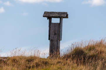 wooden chimney peaking up over the hilltop