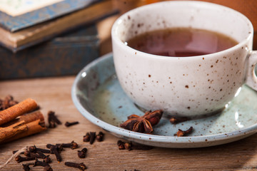 cup of coffee with cinnamon and beans