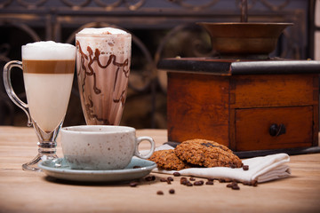 cup of coffee and cookies on wooden table
