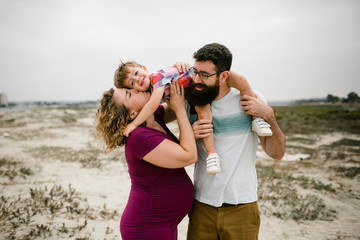 Happy parents with son at beach