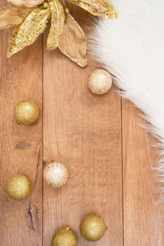 Christmas background. Gold Christmas balls on a wooden background. Winter holidays concept. Top view with copy space, vertical image