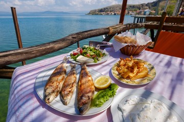 Speciality, fried Ohrid trout (Salmo letnica) served with salad and French fries, Lake Ohrid, Lin, Korca region, Albania, Europe