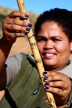 Ranger of the !Xaus Lodge shows her walking stick with aardvark and anteater decoration, Kalahari or Kgalagadi Transfrontier Park, North Cape, South Africa, Africa