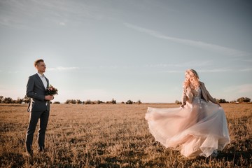 Stylish wedding photo shoot in nature at sunset.