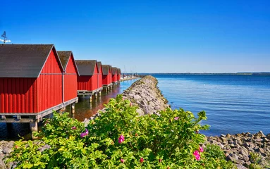 Breakwater line along Red fisher houses in the port Weiße Wiek in Boltenhagen on the Baltic Sea. Germany © DR pics