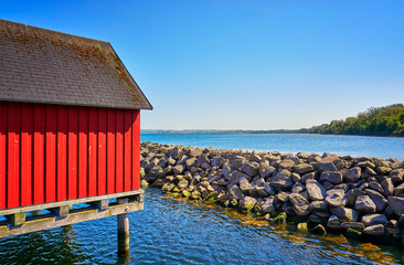 Red stilt house at the harbor Weiße Wiek in Boltenhagen on the Baltic Sea. Germany