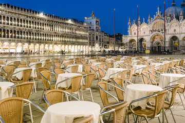 Empty tables and chairs in Piazza San Marco in the evening