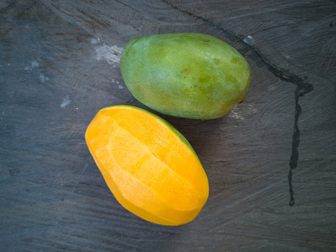 Selective focus of Malaysian or Asian favourite mango fruit called Mangga Harum Manis or Harumanis on the top of wooden table.