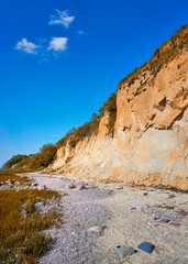 Fototapeta na wymiar Sandy Baltic Sea cliff at the Baltic Sea beach.
